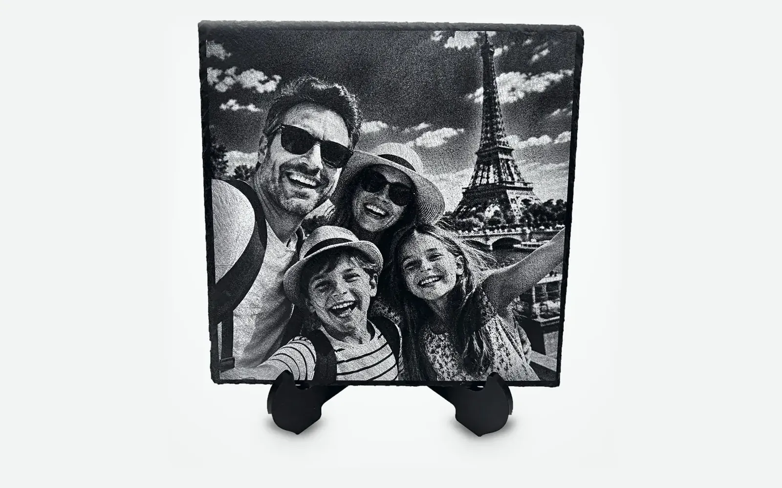 Square laser engraved slate standing on its support, with a selfie of a smiling family in front of the Eiffel Tower